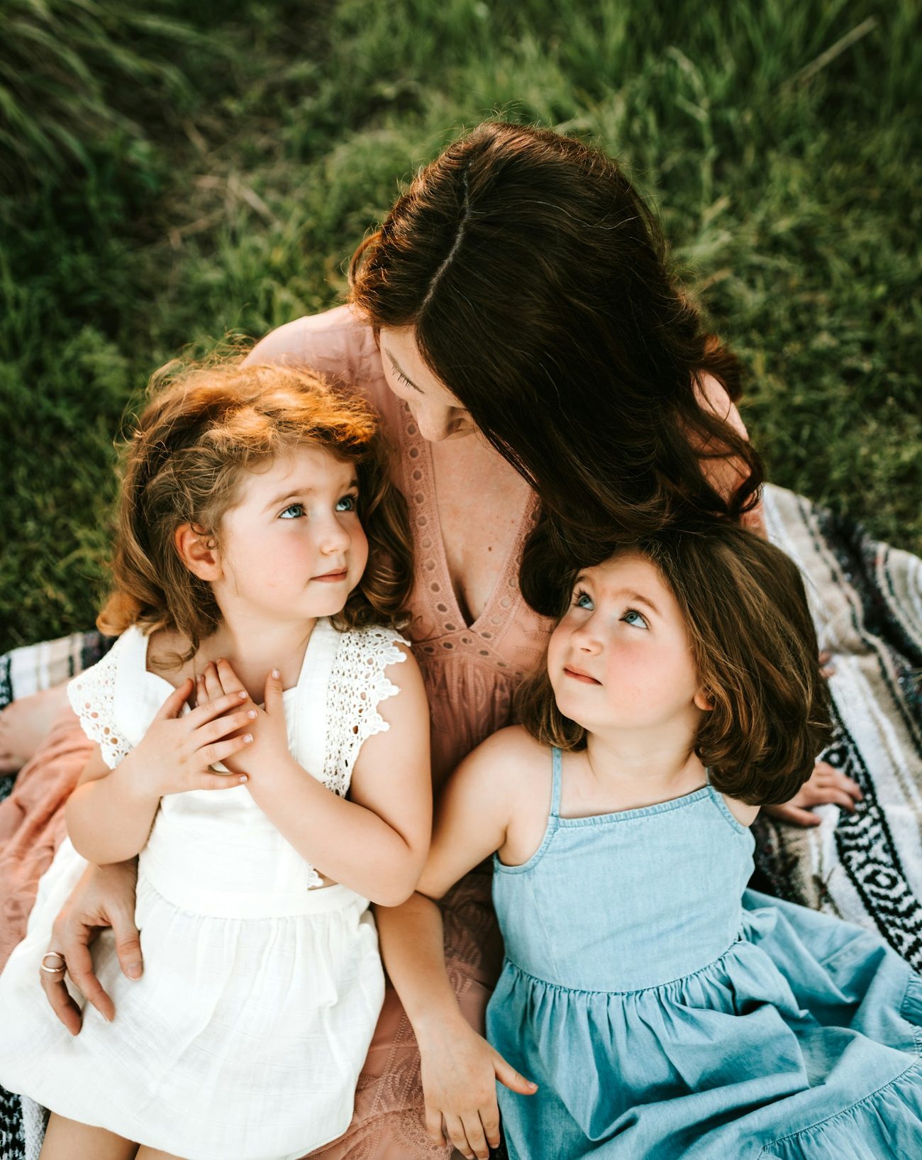 A parent and children resting together, cared for at America's Health & Wellness